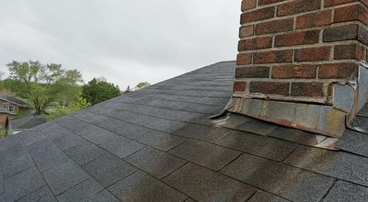 Rusted-out flashing waving its red flag at a chimney base